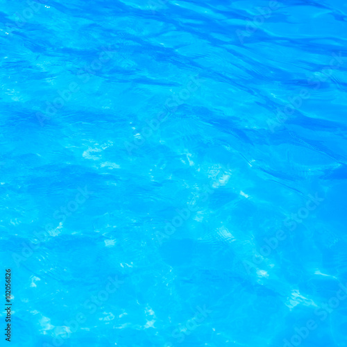 Blue pool water with sun reflections © yotrakbutda