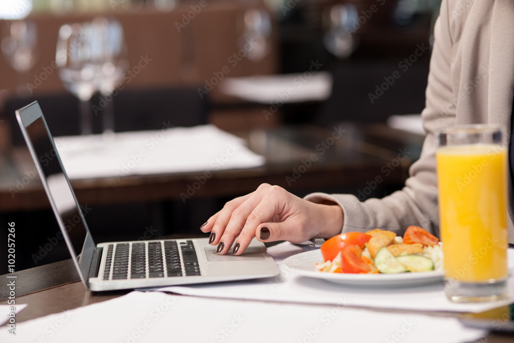 Pretty woman working with a notebook in restaurant Pretty woman working with a notebook in restaurant