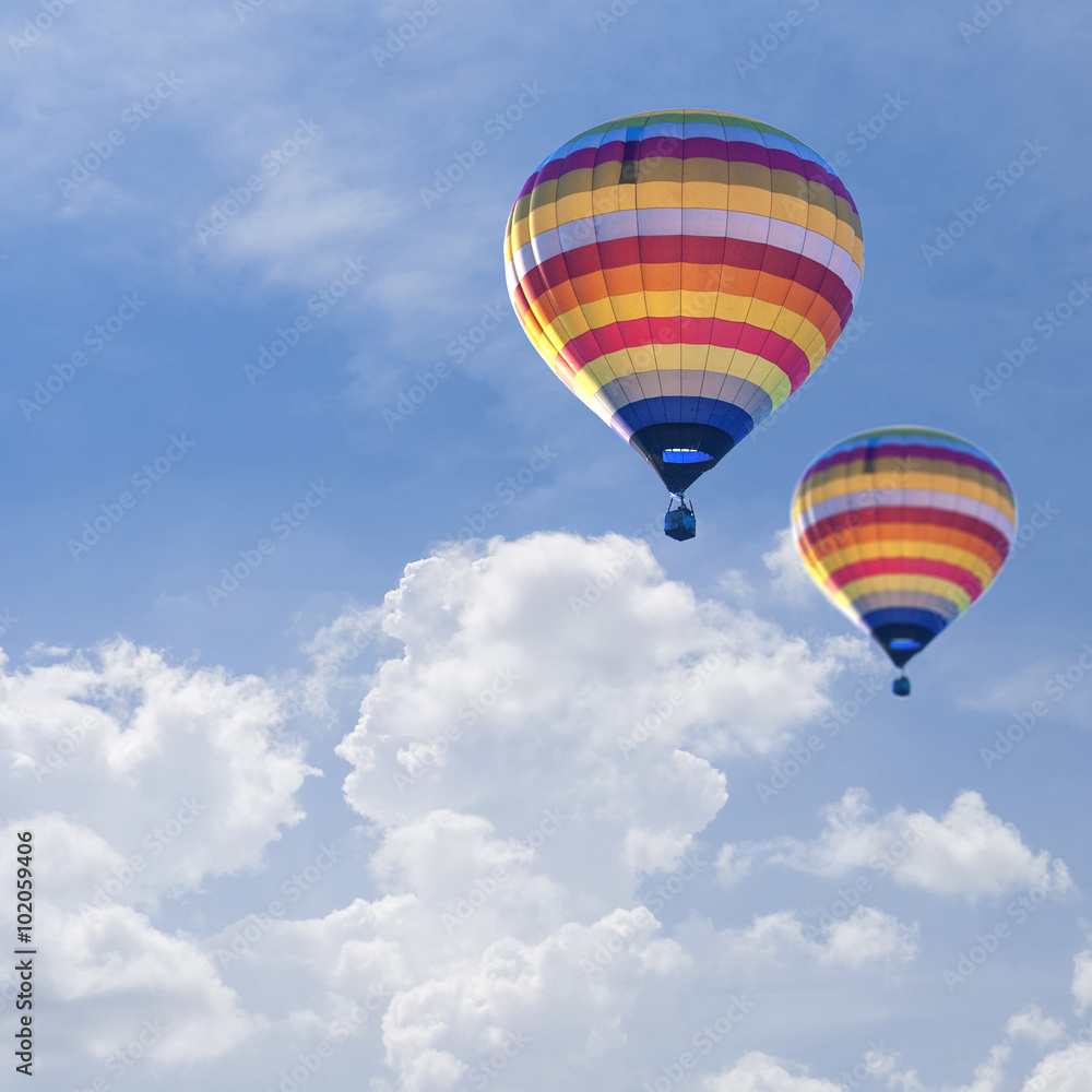 Naklejka premium Hot air balloons on Blue sky background with white cloud.