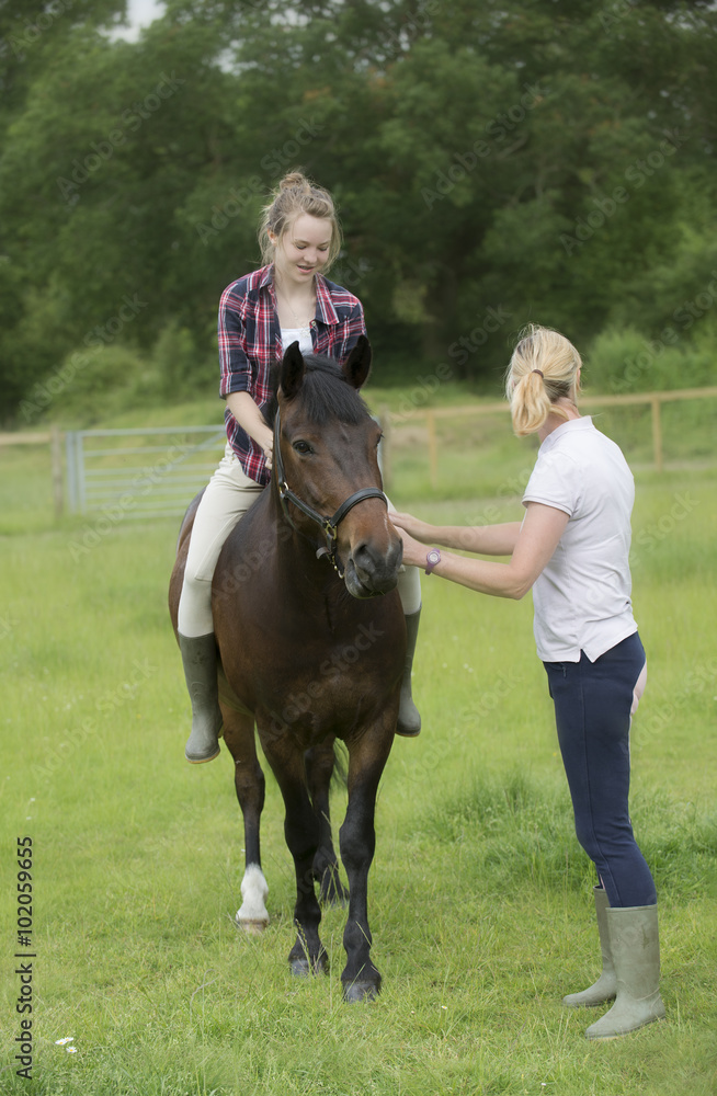 Riding bareback a teenage girl with her pet pony and an instructor Riding bareback a teenage girl with her pet pony and an instructor