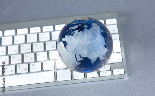 Cristal globe of the Earth on a Computer