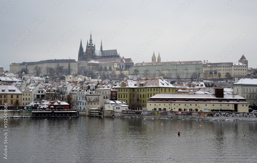 Prague castle with snow and grey sky