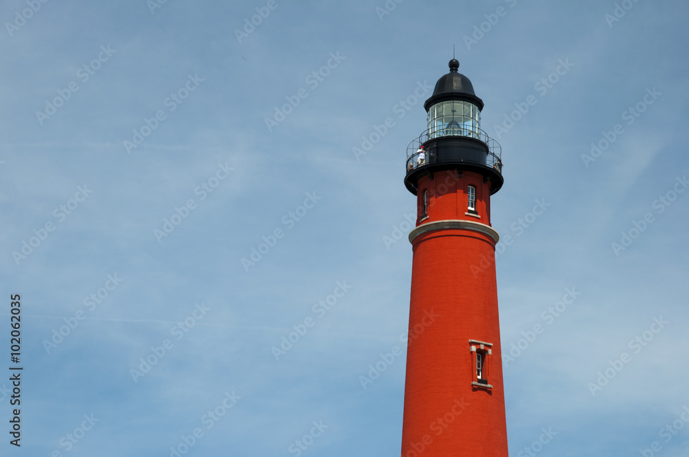 beautiful red Ponce de Leon Inlet Lighthouse against blue sky, Florida, USA
