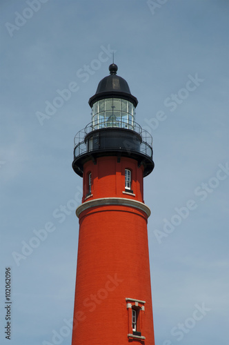 beautiful red Ponce de Leon Inlet Lighthouse against blue sky, Florida, USA