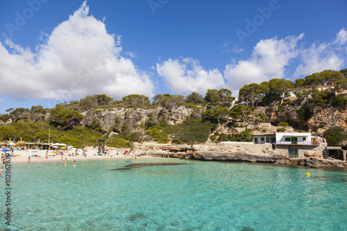 People enjoying beautiful beach with turquoise sea water in Mall