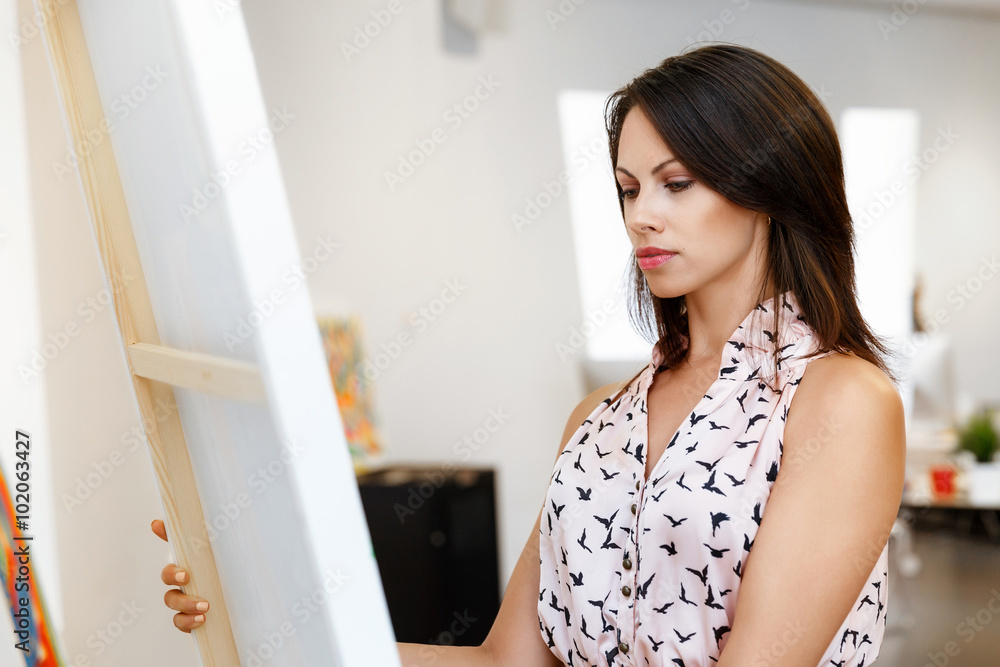 Young caucasian woman standing in art gallery front of paintings Young caucasian woman standing in art gallery front of paintings