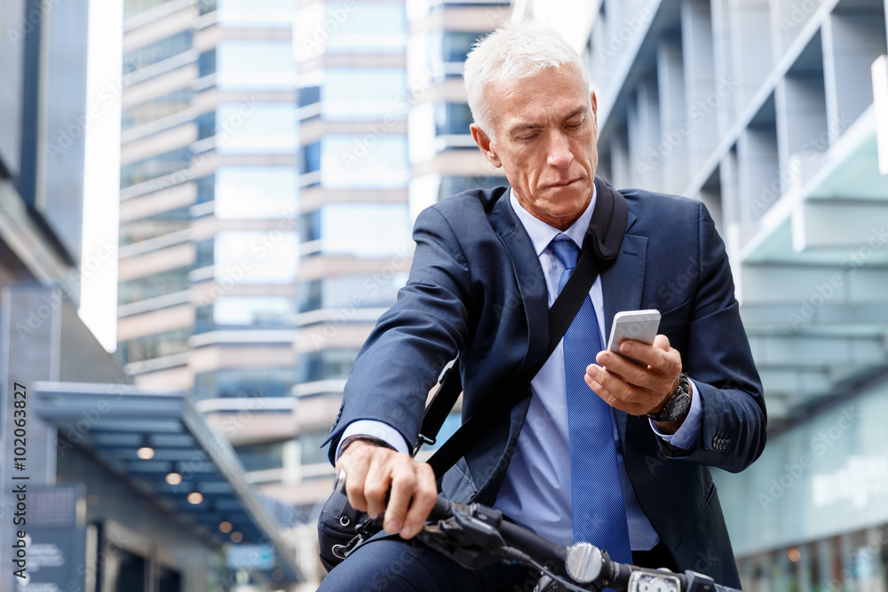 Successful businessman riding bicycle Successful businessman riding bicycle