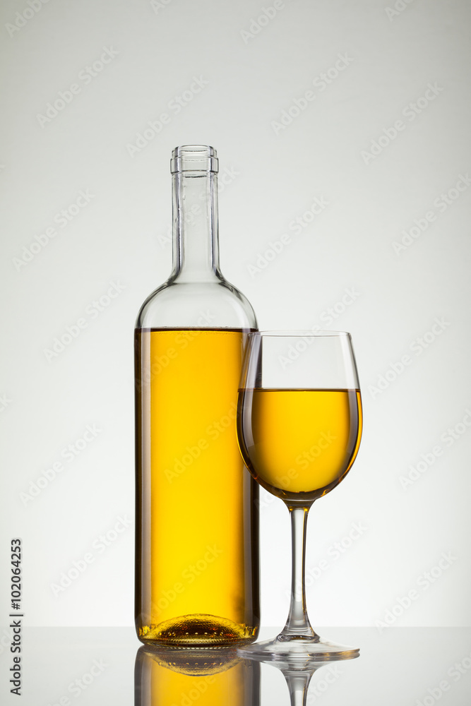 Glass of wine and bottle on white with copy space Glass of wine and bottle on white with copy space