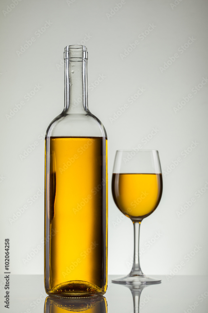 Glass of wine and bottle on white with copy space Glass of wine and bottle on white with copy space