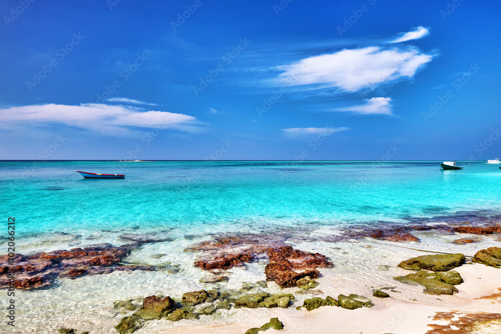 Shoreline of a tropical island in the Maldives and view of the I