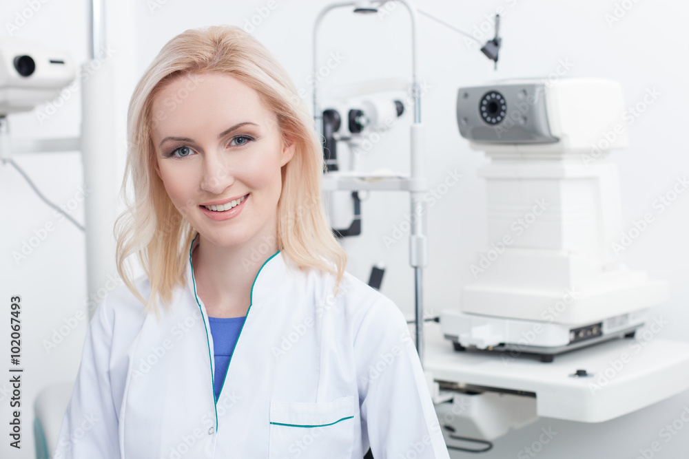 Attractive female ophthalmologist is working in clinic Attractive female ophthalmologist is working in clinic