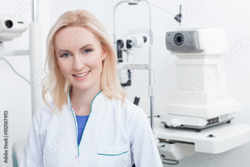 Attractive female ophthalmologist is working in clinic