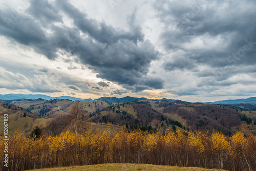 Autumn scenery in remote rural area in Transylvania and dramatic cloudy sky
