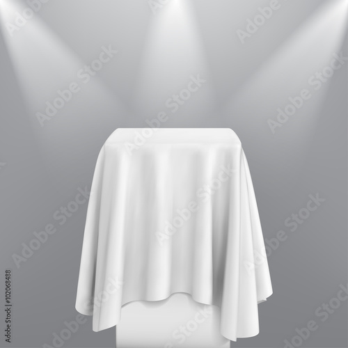 Presentation pedestal covered with a white silk cloth