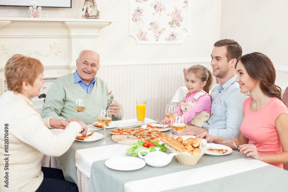 Cheerful relatives are dining together with joy