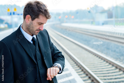 man is looking on his watch photo