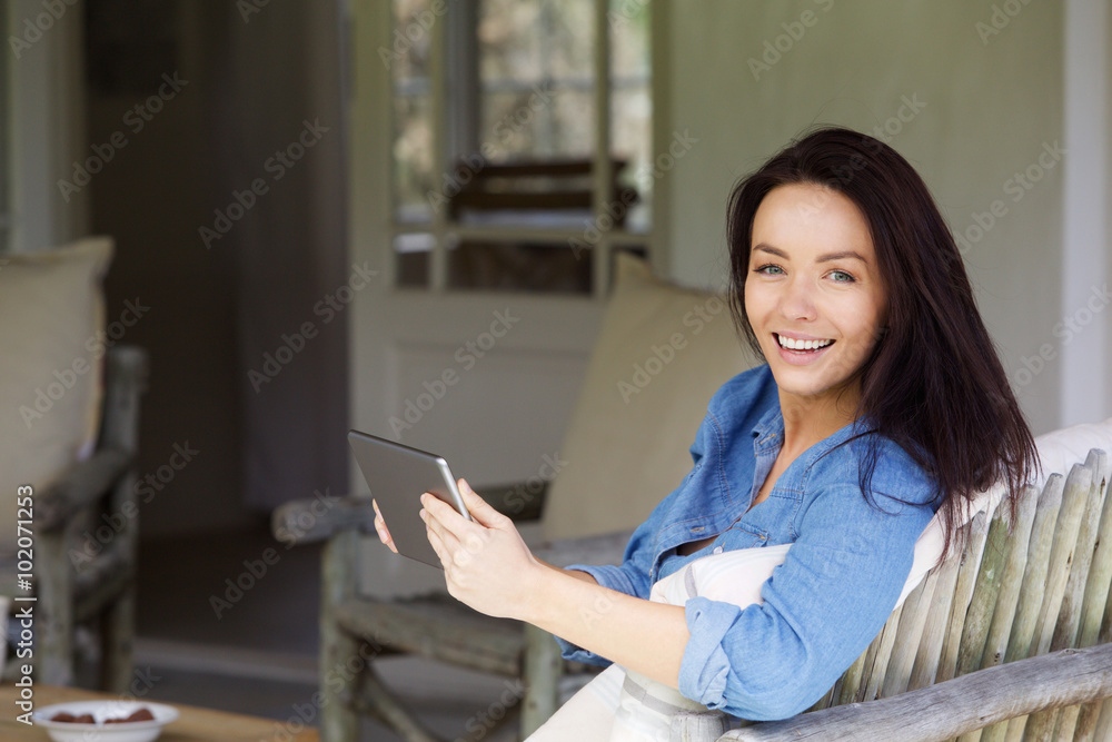 Attractive young lady relaxing with touch screen tablet