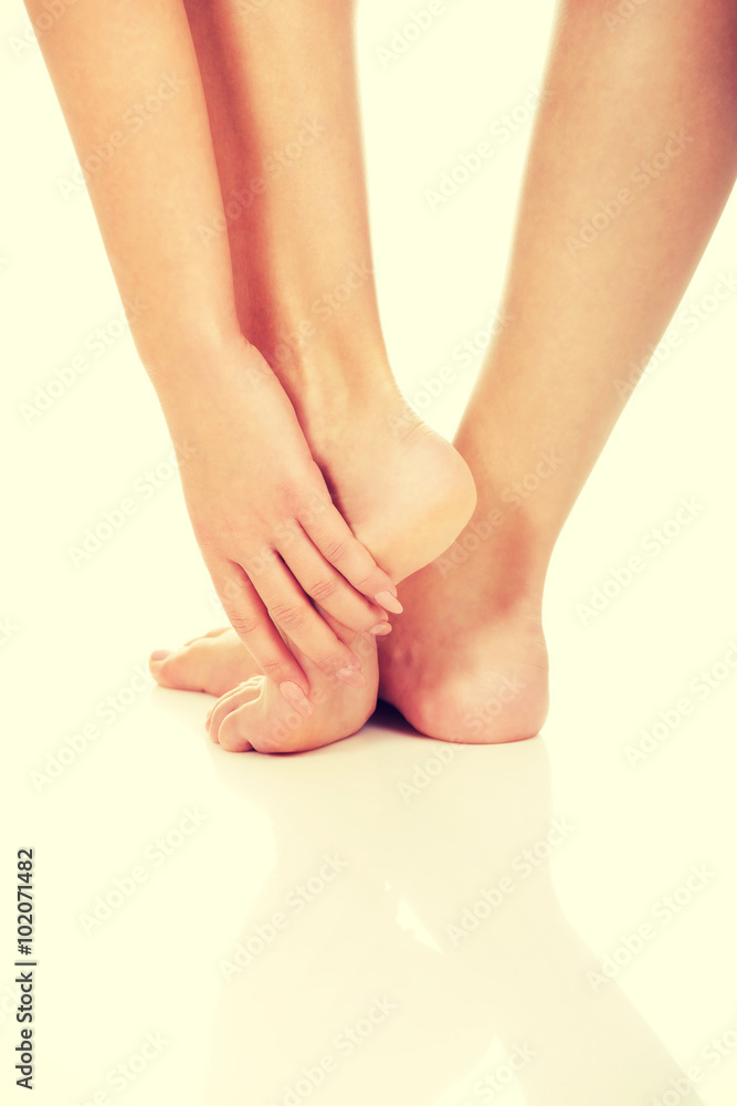 Woman touching her feet.