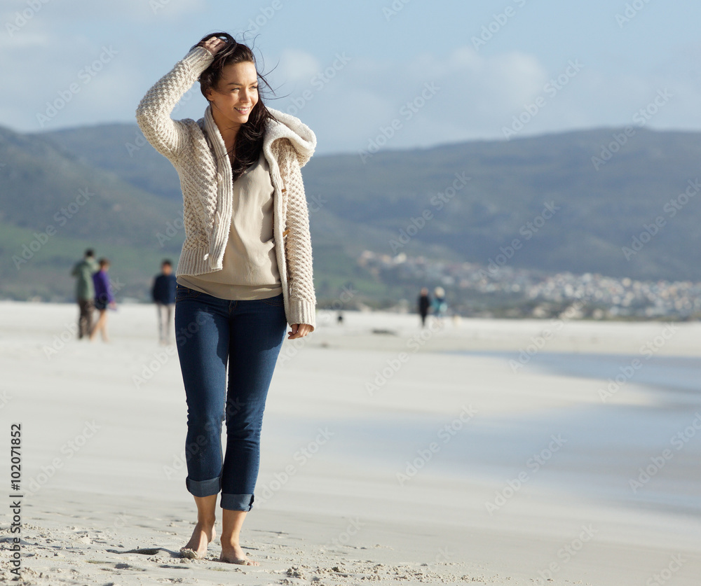 Beautiful young lady walking on the beach Beautiful young lady walking on the beach