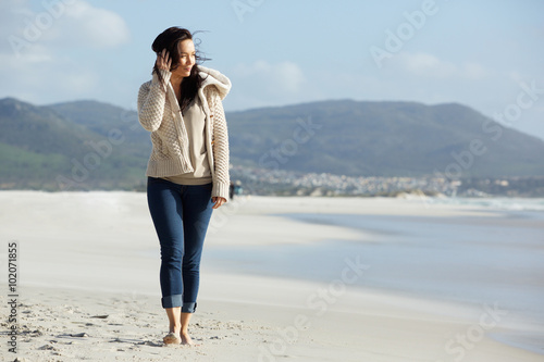 Attractive young lady walking on the sea shore