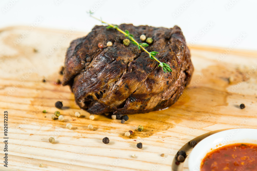 Beautiful juicy well done steak with sauce on a wooden Board Beautiful juicy well done steak with sauce on a wooden Board