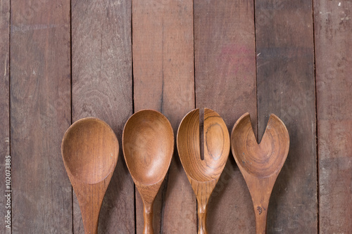 Various wooden spoons of wooden background