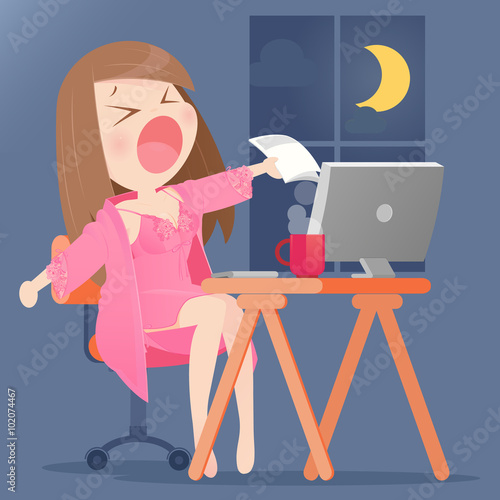 A young woman working on her computer in her home at night