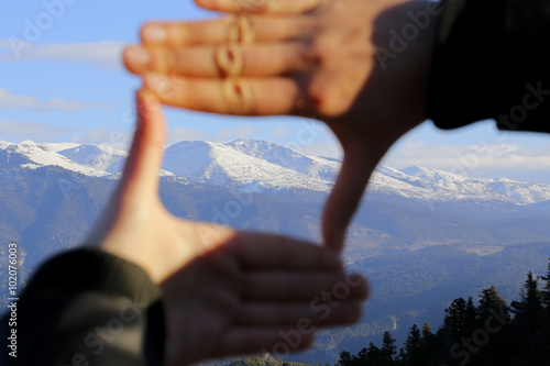 The woman hand framing distant.