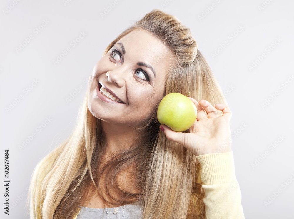 Smiling girl with green apple. Broad smile. Healthy teeth
Smiling girl with green apple. Broad smile. Healthy teeth