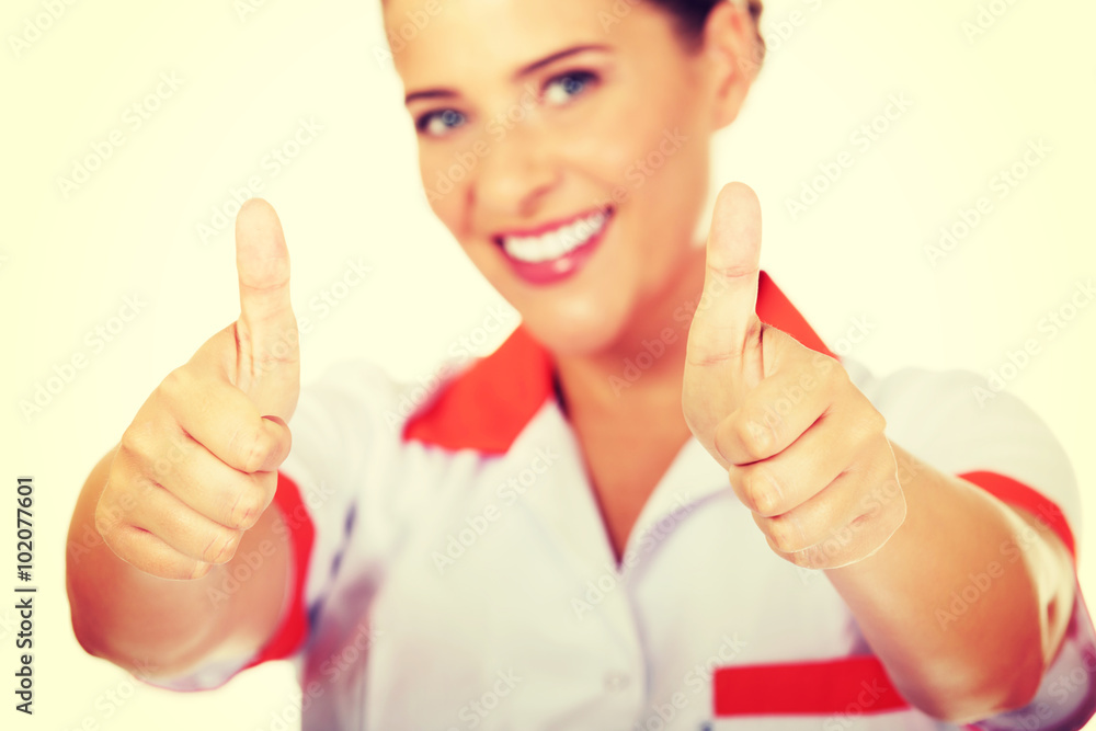 Young smile female doctor or nurse with thumbs up Young smile female doctor or nurse with thumbs up