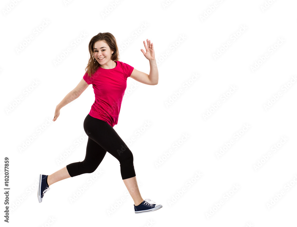 Teenage girl jumping on white background