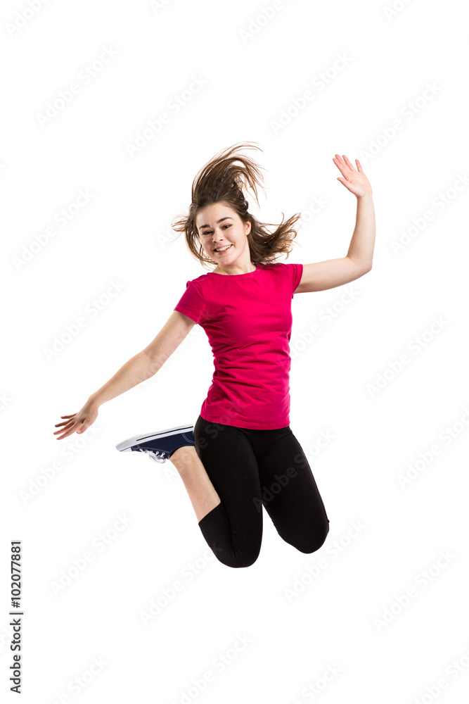 Teenage girl jumping on white background