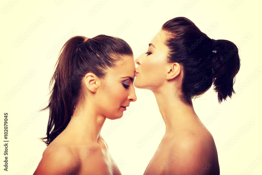 Woman kissing friend in forehead. Woman kissing friend in forehead.