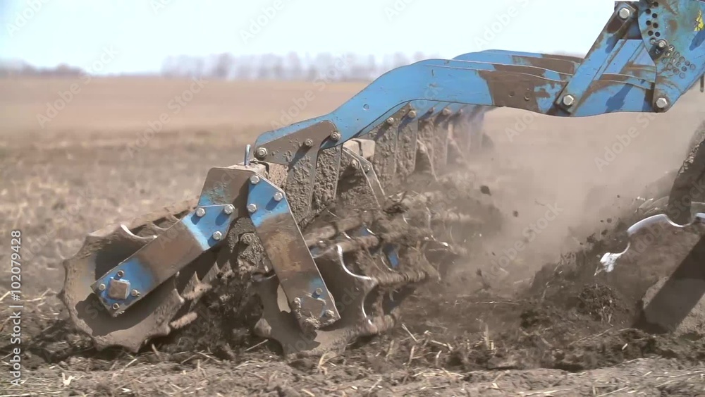 Close up of a tractor seeding, plowing and cultivating the field in the spring. Slow Motion Shot. Close up of a tractor seeding, plowing and cultivating the field in the spring. Slow Motion Shot.