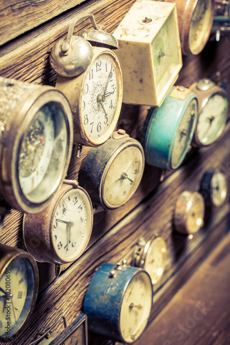 Vintage wooden wall with clocks
