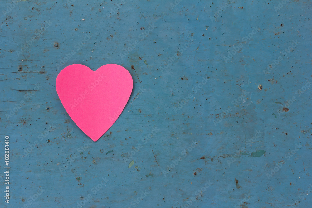 Valentine - paper pink heart against a blue painted surface. Copy space. Free space for text, Close-up, top view