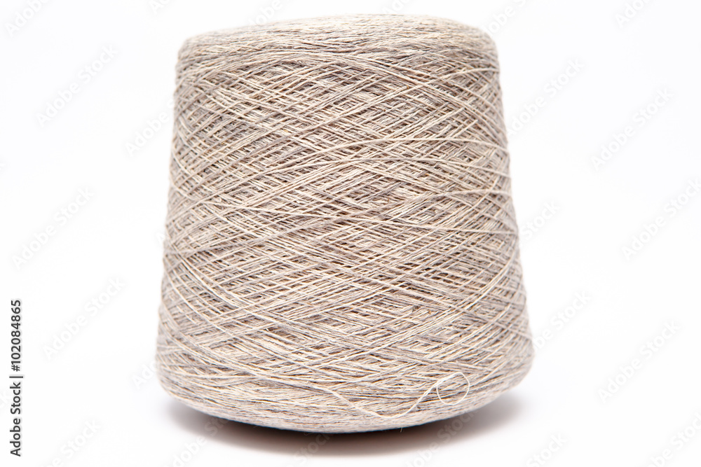 The cone of colored wool thread on a white background The cone of colored wool thread on a white background