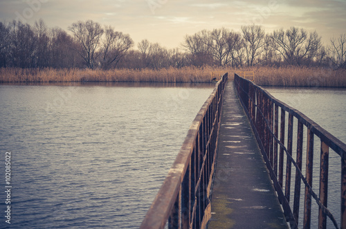 Wallpaper Mural Narrow steel bridge over autumn lake Torontodigital.ca