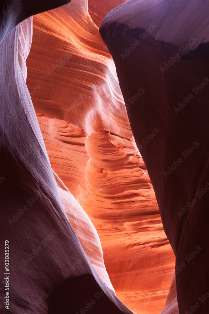 Sunlight plays deep into Lower Antelope Canyon Page Arizona USA creating the amazing colors and patterns from light reflecting on the silica rich limestone