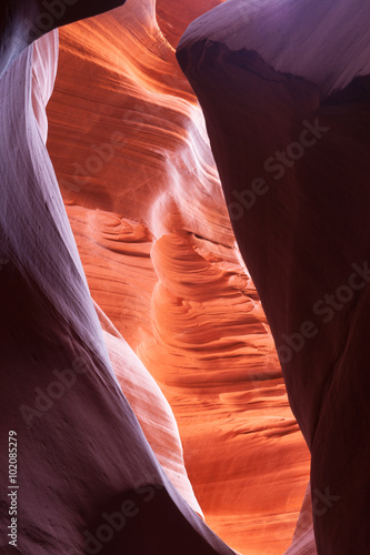 Sunlight plays deep into Lower Antelope Canyon Page Arizona USA creating the amazing colors and patterns from light reflecting on the silica rich limestone