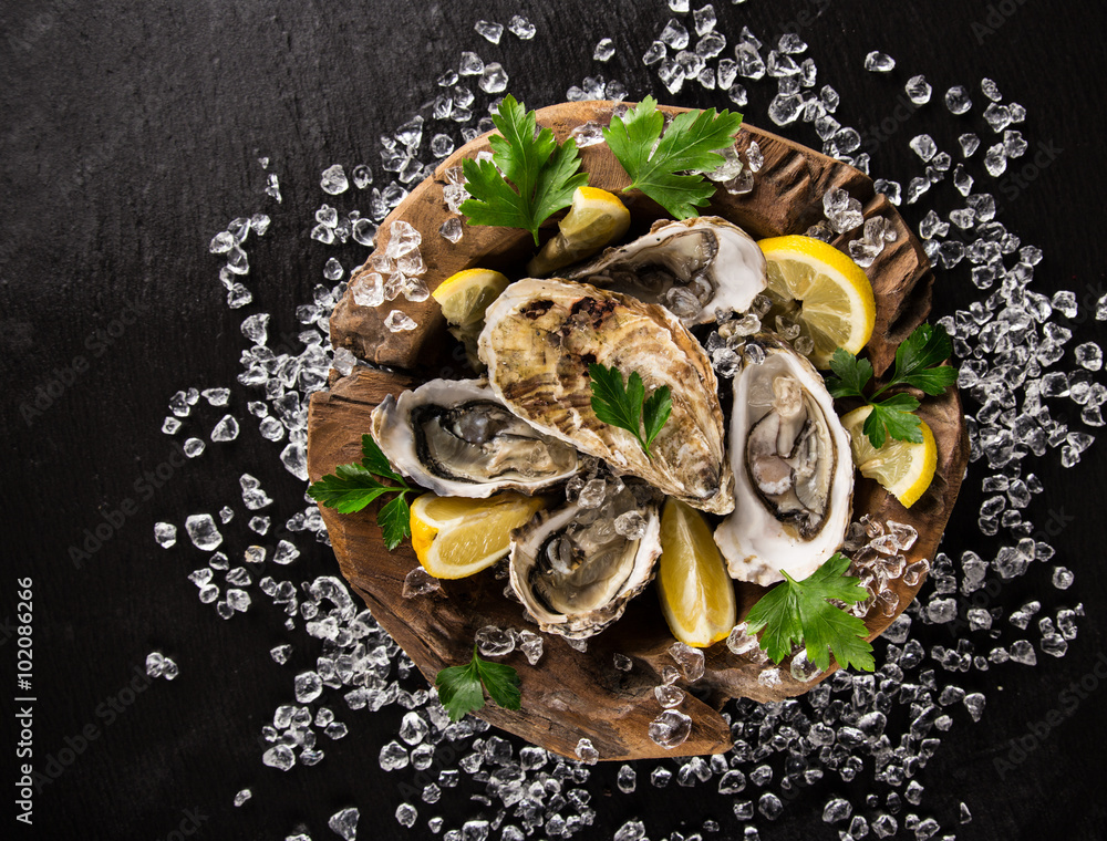 Fresh oysters on a black stone