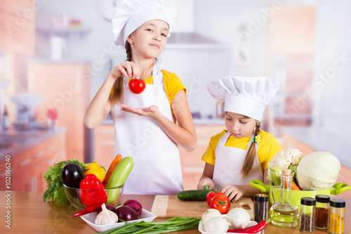 twin girl chef cut vegetables