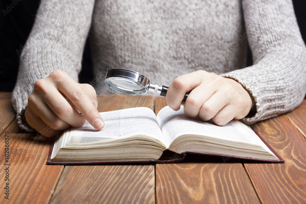 Closeup woman hand holding pocket book to read Closeup woman hand holding pocket book to read