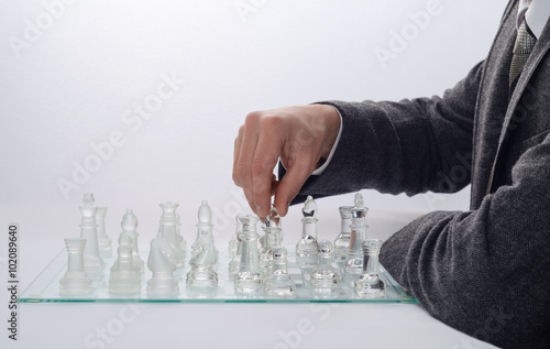 businessman playing chess on a light background