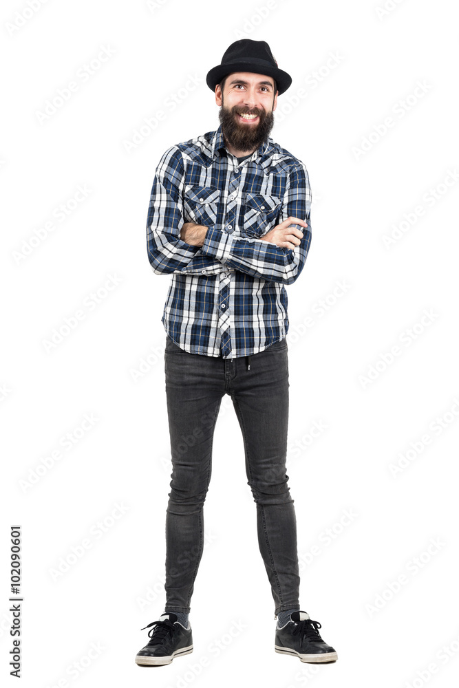 Laughing hipster wearing fedora black hat with crossed arms looking at camera. Full body length portrait isolated over white studio background. Laughing hipster wearing fedora black hat with crossed arms looking at camera. Full body length portrait isolated over white studio background.