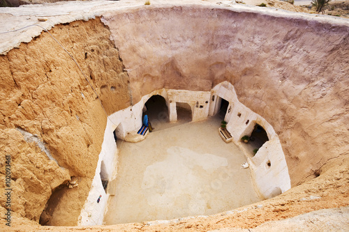 Tunisia. Matmata - the largest region of the troglodyte communities. One of many dwellings - fragment of courtyard excavated in the rock (circular crater a few meters deep) photo