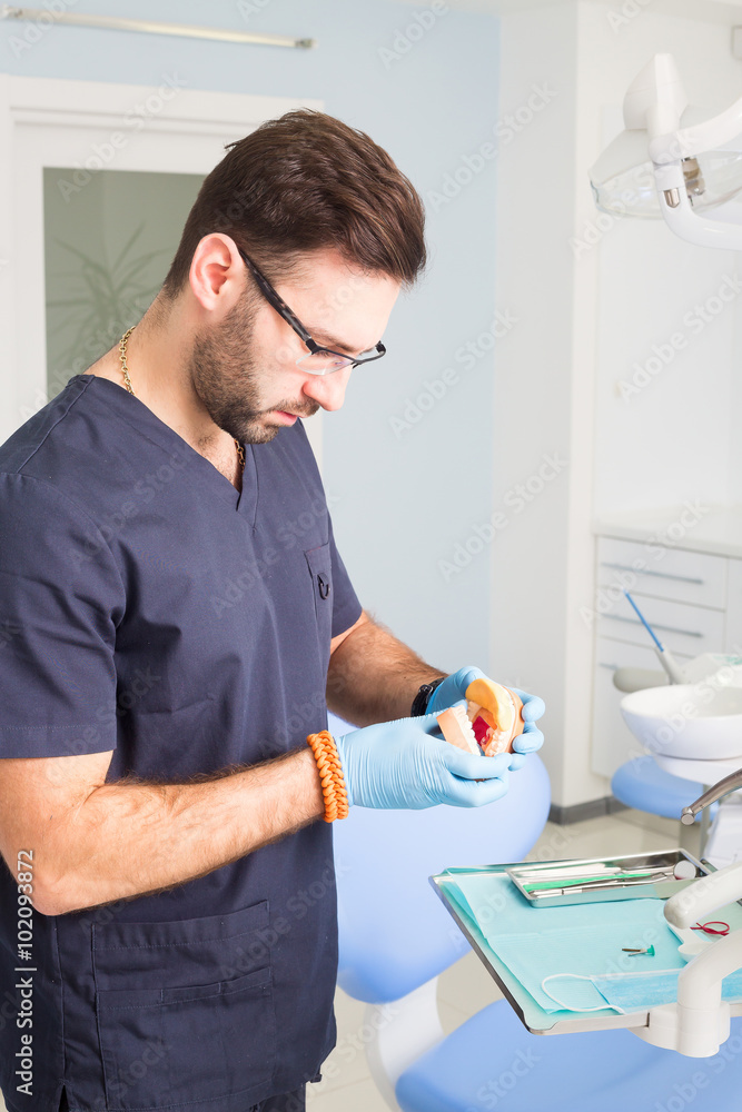 Closeup of male dental technician working in dental laboratory.dental acrylic prosthesis