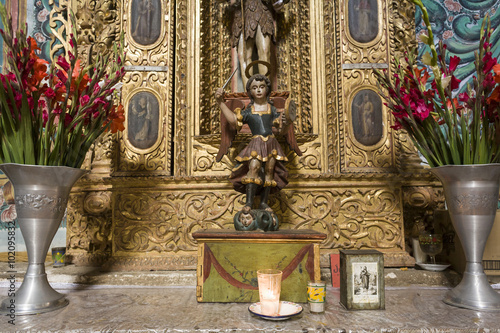 Religious icons on altar in Catholic church, Teotitlan del Valle, Oaxaca, Mexico photo
