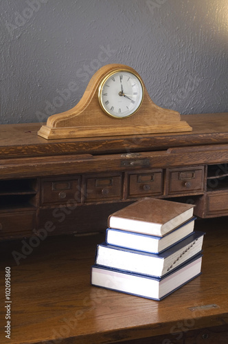 Books on the Antique Rolltop Desk with Mantle Clock