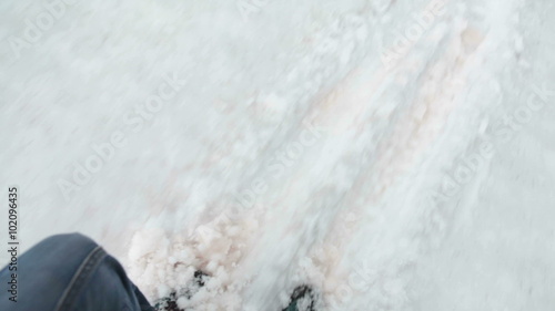 Climber slipping on the snowy glacier while descenting from the mountain pass, pov
